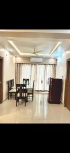 a dining room with a table and chairs and a television at Virat in Jāmb