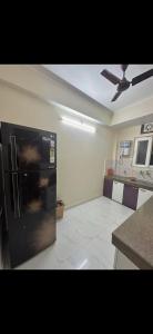 a kitchen with a black refrigerator in a room at Virat in Jāmb