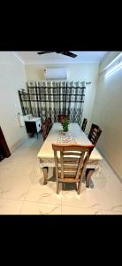 a dining room with a table and chairs and a table at Virat in Jāmb +29 photos