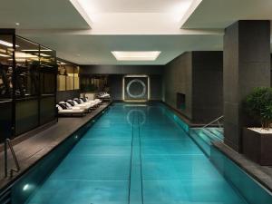 a large swimming pool in a hotel lobby at Mandarin Oriental Hyde Park, London in London