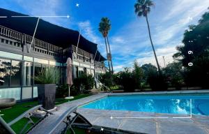 a swimming pool in front of a house at Hephzibah Inn River Cabin in Hermon