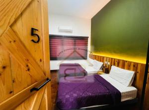 a small room with two beds in a wooden room at 188 Private Pool Mansion Ipoh KTV BBQ 30Pax in Ipoh +22 photos
