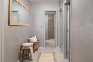 einen Flur mit einem Spiegel und einem Hocker in einem Zimmer in der Unterkunft Modern Apartments Marija in Pakoštane + 44 Fotos