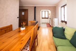 a living room with a wooden table and a couch at Millefiori house in Antronapiana