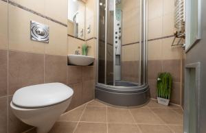 a bathroom with a toilet and a shower and a sink at Европейска площа in Kyiv