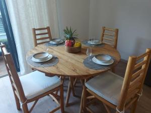 a wooden table with a bowl of fruit on it at Maca'z Grand Bois 2-4 personnes in Saint-Pierre