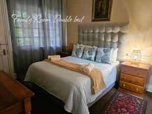 a bedroom with a large bed with towels on it at Silver Mist Guest House and Country Inn in Kaapsehoop