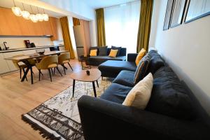 a living room with a couch and a table at FLH - Relax Home in Sibiu