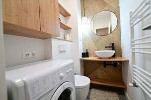 a laundry room with a washing machine and a mirror at FLH - Relax Home in Sibiu +30 photos