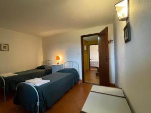 a hospital room with two beds and a mirror at Casa do Vale - Douro Valley Cottage in Resende