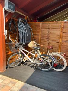 two bikes parked next to each other in a garage at Izabella Apartman Bogács in Bogács