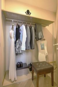 a walk in closet with a wedding dress and clothes at Green Court Residence Jinqiao Diamond Shanghai in Shanghai