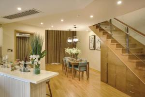 a kitchen and dining room with a table and a staircase at Green Court Residence Jinqiao Diamond Shanghai in Shanghai