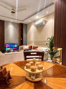 a living room with a table and a couch at Modern 2BR Central Apartment Lahore Zameen Opal in Lahore