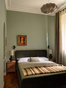 a bedroom with a bed and a ceiling fan at Camelia in Belgirate