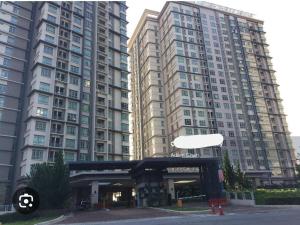 a large building with two large tall buildings at Peacehome 910 in Cyberjaya
