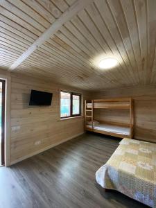 a bedroom with wooden walls and a bed in a room at GreenHotel in Chornomorsk