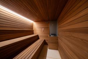 a sauna with wooden walls and benches in a room at Excelsior Palace Portofino Coast in Rapallo