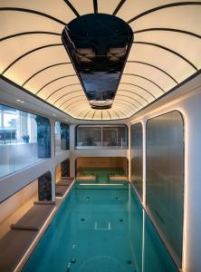 a swimming pool on a yacht with a ceiling at Excelsior Palace Portofino Coast in Rapallo