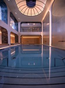 a swimming pool on a yacht with a circular ceiling at Excelsior Palace Portofino Coast in Rapallo
