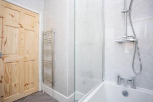 a bathroom with a shower and a white tub at Meldon Terrace Parking Wi-fi in Woodhorn +60 photos