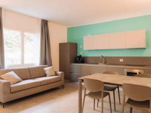 a living room with a couch and a table at Holiday Apartments Campoverde in Salò
