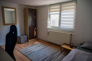 a bedroom with a bed and a window and a rug at Gajic & Milini in Banja Luka