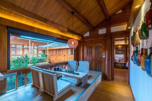 a kitchen with a counter and a large window at Lijiang half yard hotel in Lijiang