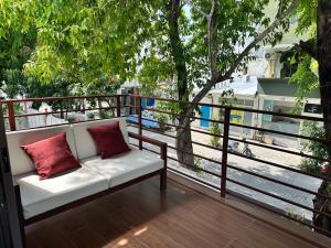 a bench on a balcony with a view of a street at Island Getaway Villa - 5BR with Patio in Male City
