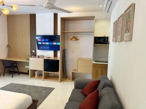 a living room with a couch and a television at Island Getaway Villa - 5BR with Patio in Male City