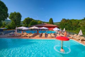 a person in the water in a pool at a resort at Camping Trasimeno in Passignano sul Trasimeno