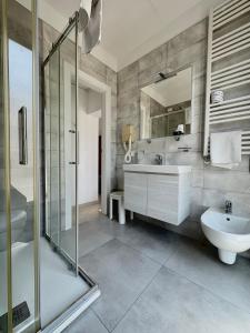 a bathroom with a sink and a mirror and a tub at Hotel Fortuna in Chioggia +22 photos