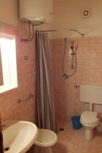 a bathroom with a shower and a toilet and a sink at Elba Casale al Mare Cm2a in Marina di Campo