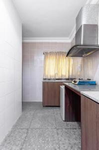 a kitchen with a sink and a counter top at Peace Luxury Hotel and Apartment in Jahi