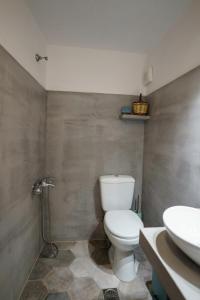 a bathroom with a toilet and a sink at Nostos in Hydra +18 photos