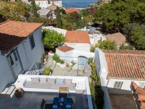 an overhead view of a white couch on a balcony at Nostos in Hydra