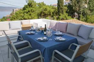 a table with a blue table cloth on a patio at Nostos in Hydra