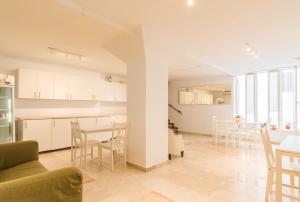 a living room and kitchen with a table and chairs at Hostal Altamar in Almuñécar