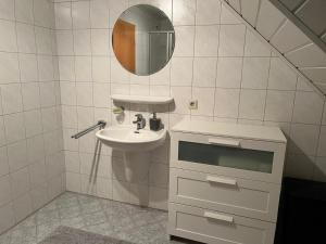 a bathroom with a sink and a mirror at Ferienwohnung Anne in Großheide