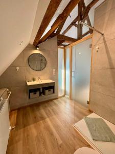 a bathroom with a sink and a mirror on the wall at Les gîtes de la ferme du moulin in Binche