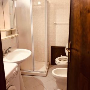 a bathroom with a shower and a toilet and a sink at Casa vacanze vista mare a Budoni - sam01 in Tanaunella