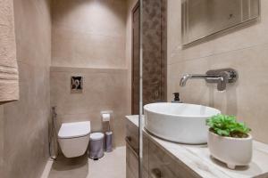 a bathroom with a sink and a toilet at M&A Boutique House in Zakynthos +12 photos