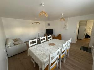 a living room with a table and a couch at Ty-Kokoon in Saint-Quay-Portrieux +9 photos