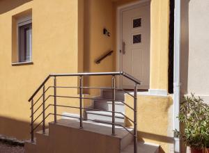 a staircase leading to a door of a house at M&A Boutique House in Zakynthos