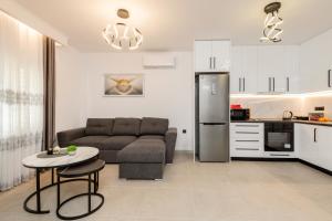 a living room with a couch and a table and a kitchen at M&A Boutique House in Zakynthos