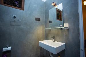 a bathroom with a sink and a mirror at Mishu House in Ahangama