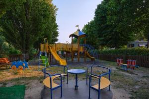 a park with a playground with a slide at Camping Trasimeno in Passignano sul Trasimeno