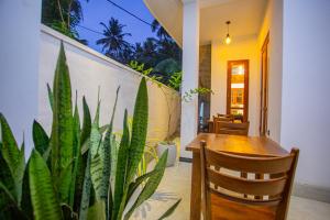 a dining room with a table and a plant at Mishu House in Ahangama +13 photos