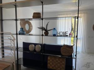 a living room with a blue couch and shelves at Golfo Ameno Apartment in Portovenere