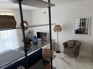 a living room with a glass shelf and a chair at Golfo Ameno Apartment in Portovenere